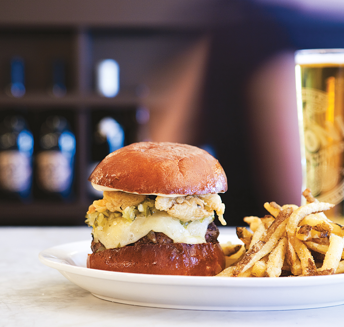 The neptuneburger comes laden with fried oysters and cheddar. Photo by Keller + Keller.