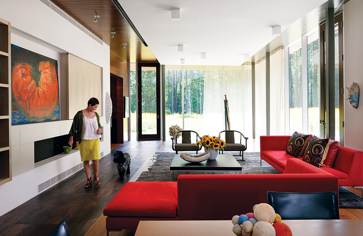 Meadow Views: Deborah Hawkins and her English cocker spaniel, Cooper, stroll through the living room, outfitted with B & B Italia sofas from Montage. Photograph by Greg Premru
