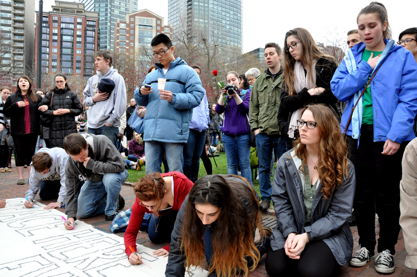 Mourners sign a banner on Boston Common. Photo by Regina Mogilevskaya