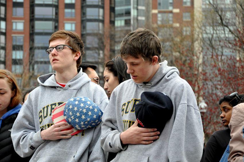 mourners in Suffolk university sweatshirts pay tribute to victims of Monday's tragedy. Photo by Regina Mogilevskaya