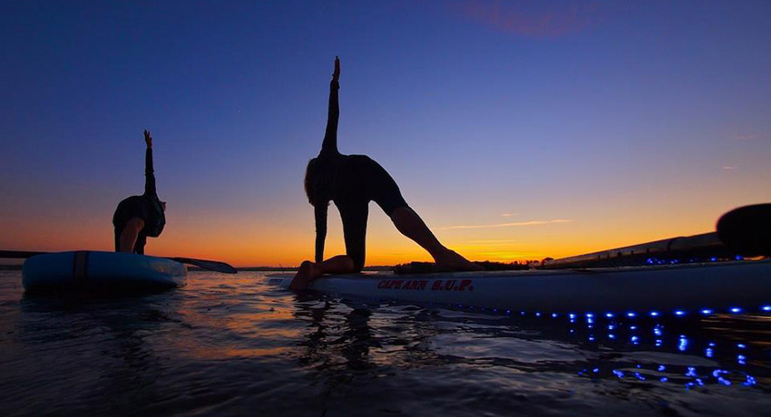 Paddleboard yoga photo via Cape Ann Paddleboarding Facebook.