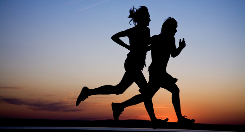 Looking for someone to go on sunset runs with? Running couple photo via Shutterstock.
