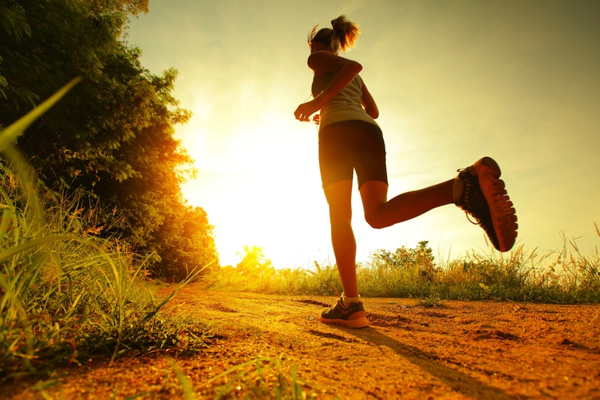 Running without a device can help you focus on the present moment, rather than thinking about stressors. Sunset run image via Shutterstock.