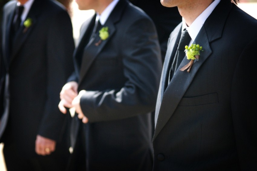 Groomsmen with boutonnieres photo via Shutterstock