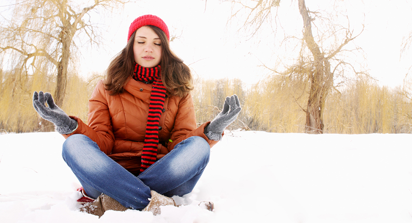 You can still relax in winter weather. Meditating in the snow photo via shutterstock. 