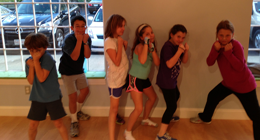 Kids getting ready for a kickboxing class. 
