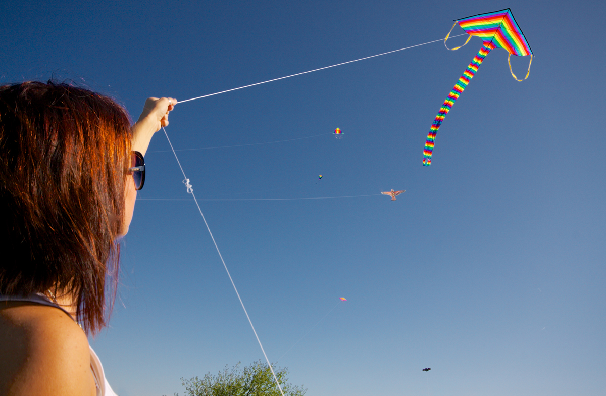A Woman Flying a Kite via Shutterstock