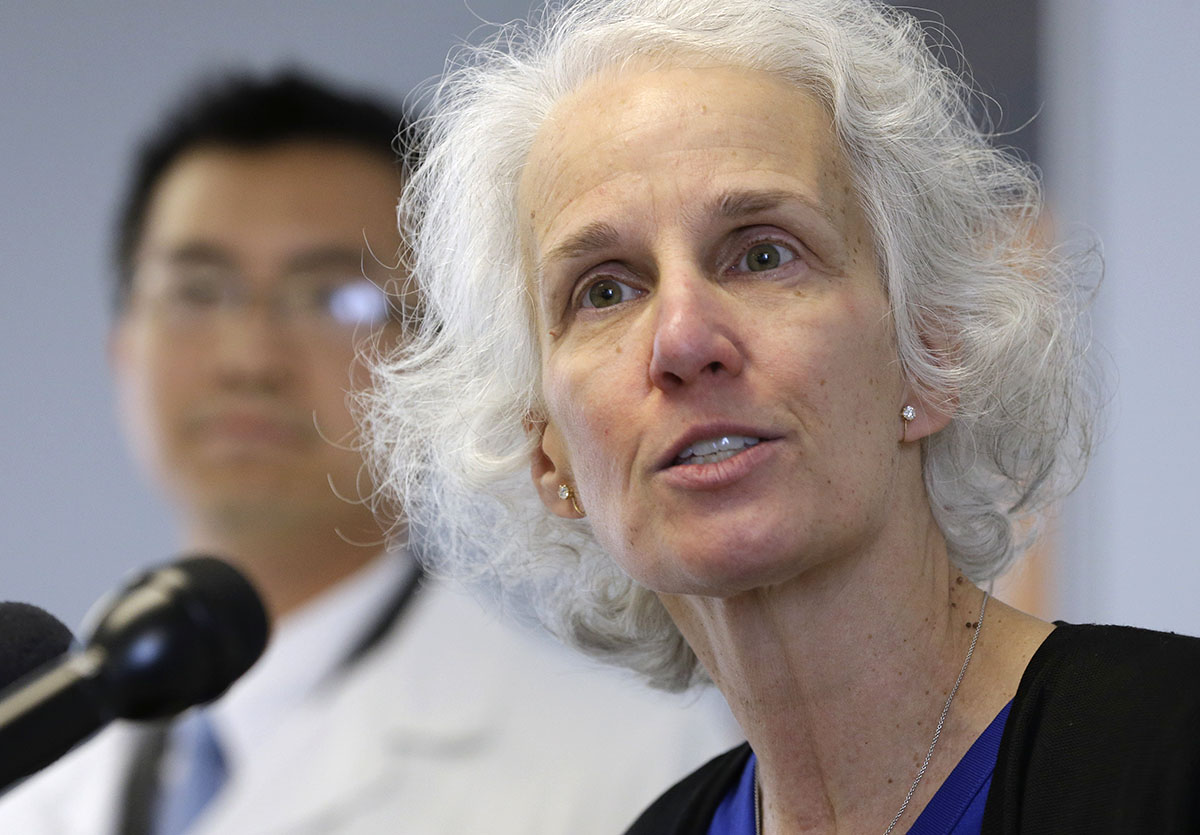 Dr. Anita Barry, head of the Infectious Disease Bureau at the Boston Public Health Commission, right, takes questions from members of the media as Huy Nguyen, medical director and interim executive director of Boston Public Health Commission, left, looks on during a news conference, Monday, Oct. 13, 2014, in Boston. Barry and Nguyen discussed preparations in place in the event a person was diagnosed with Ebola in the Boston area. (Photo via Associated Press)