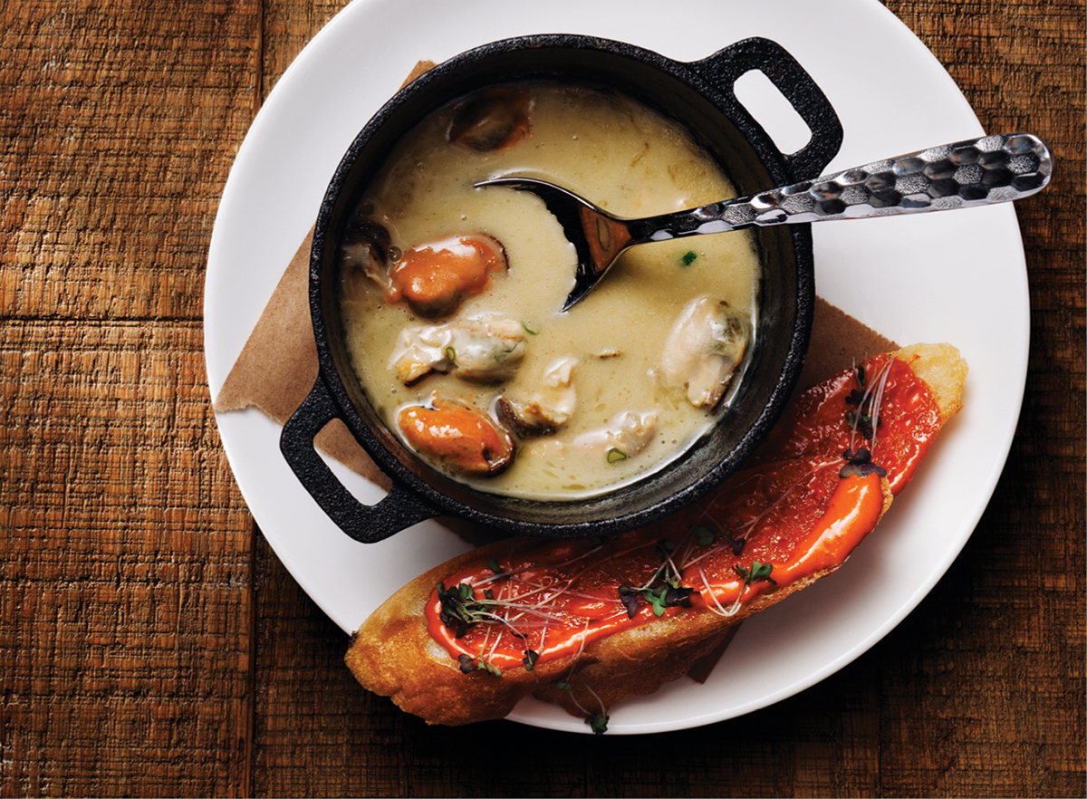 New England seafood stew, served with a guajillo-aioli-smeared baguette; Photograph by Adam Detour.