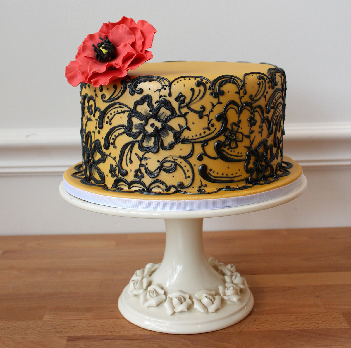 black lace design drawn freehand using a piping bag of royal icing over of a fondant cake/Photo courtesy of Oakleaf Cakes
