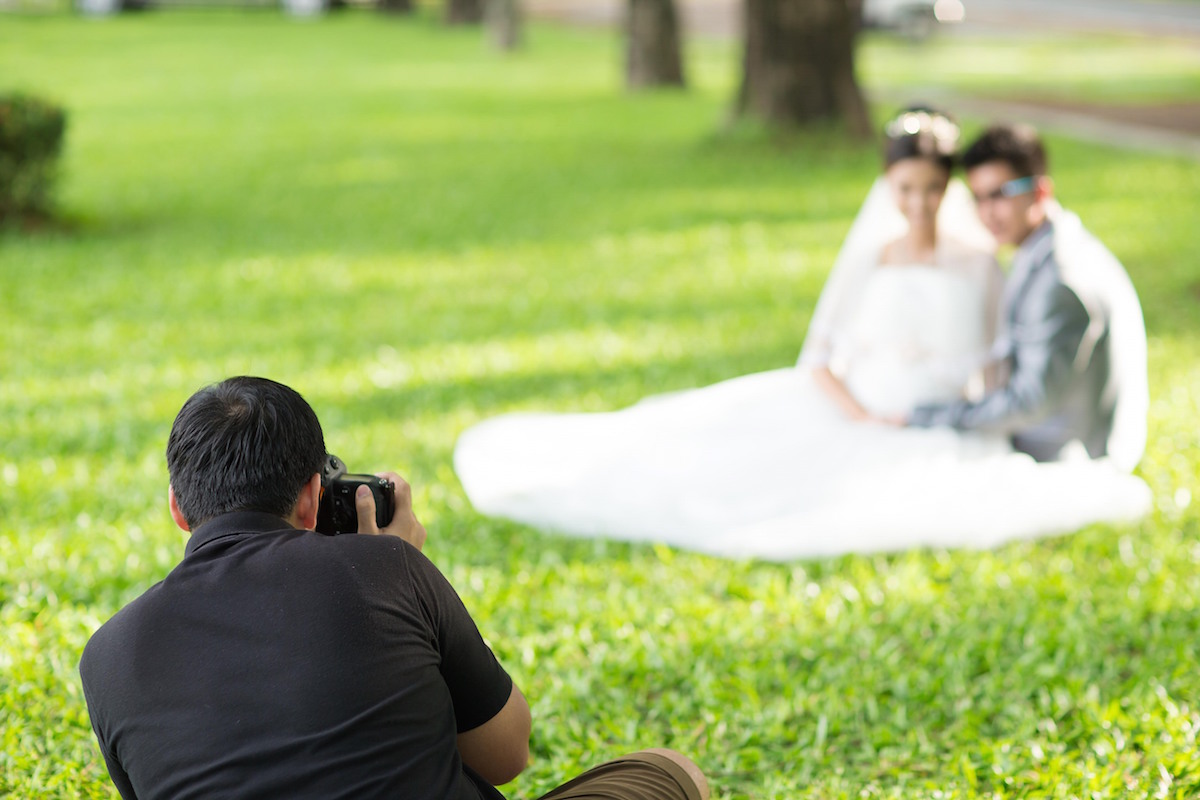 Wedding Photographer in Action via Shutterstock