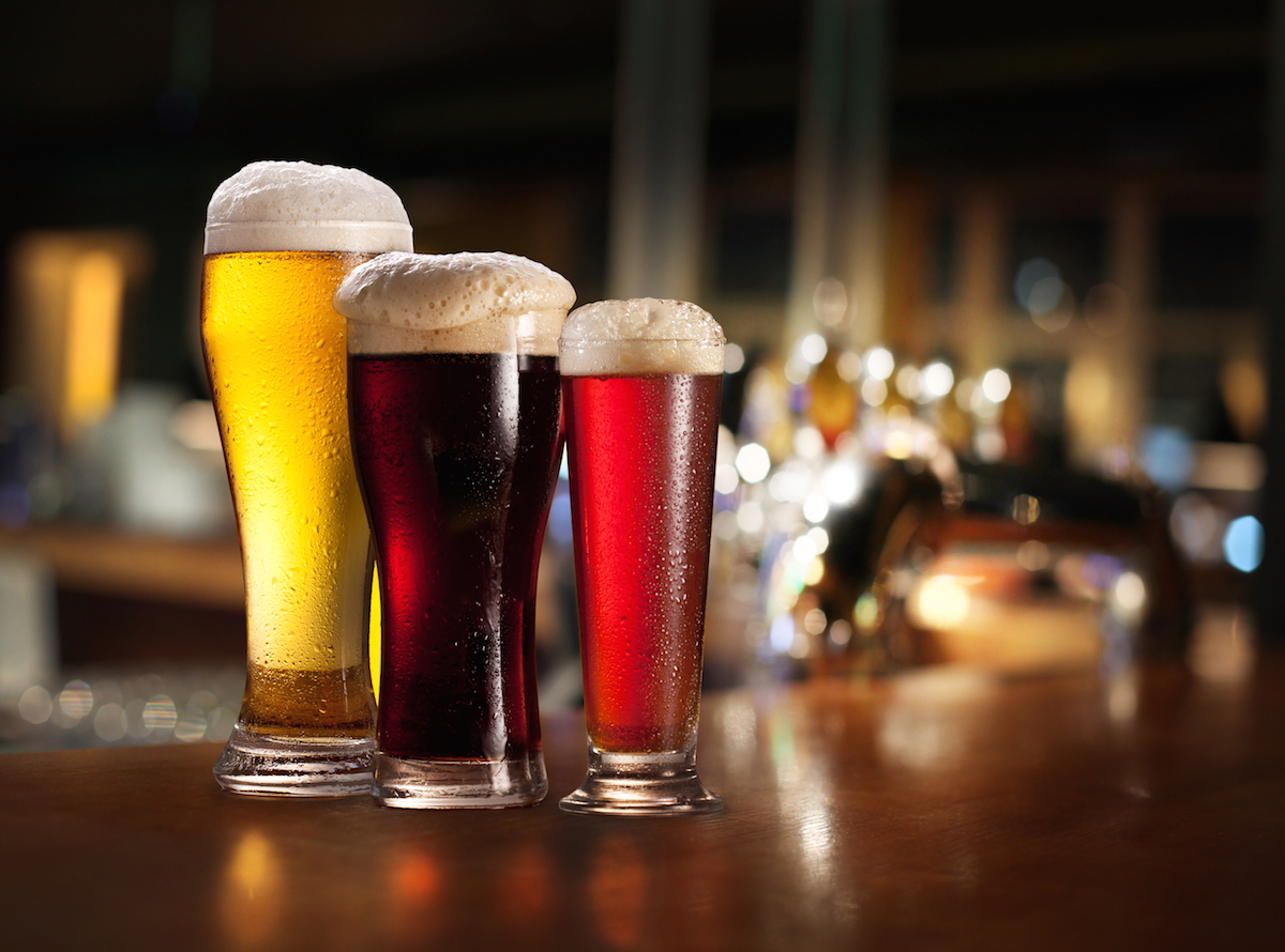 Glasses of light and dark beer on a pub background via Shutterstock