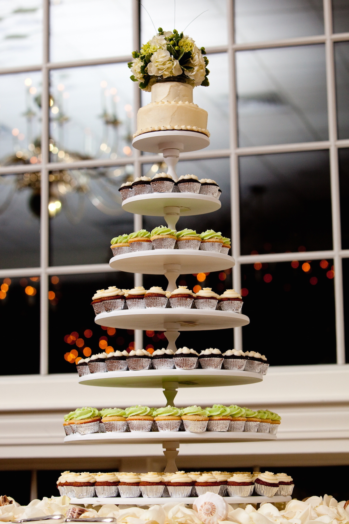 mini cupcakes on a multi level tier in different colors via Shutterstock