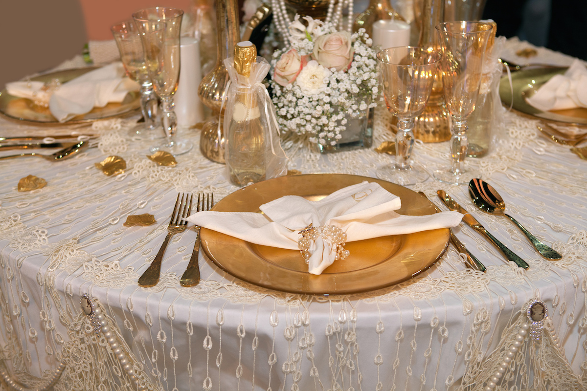 Luxurious wedding dinner with golden theme via Shutterstock