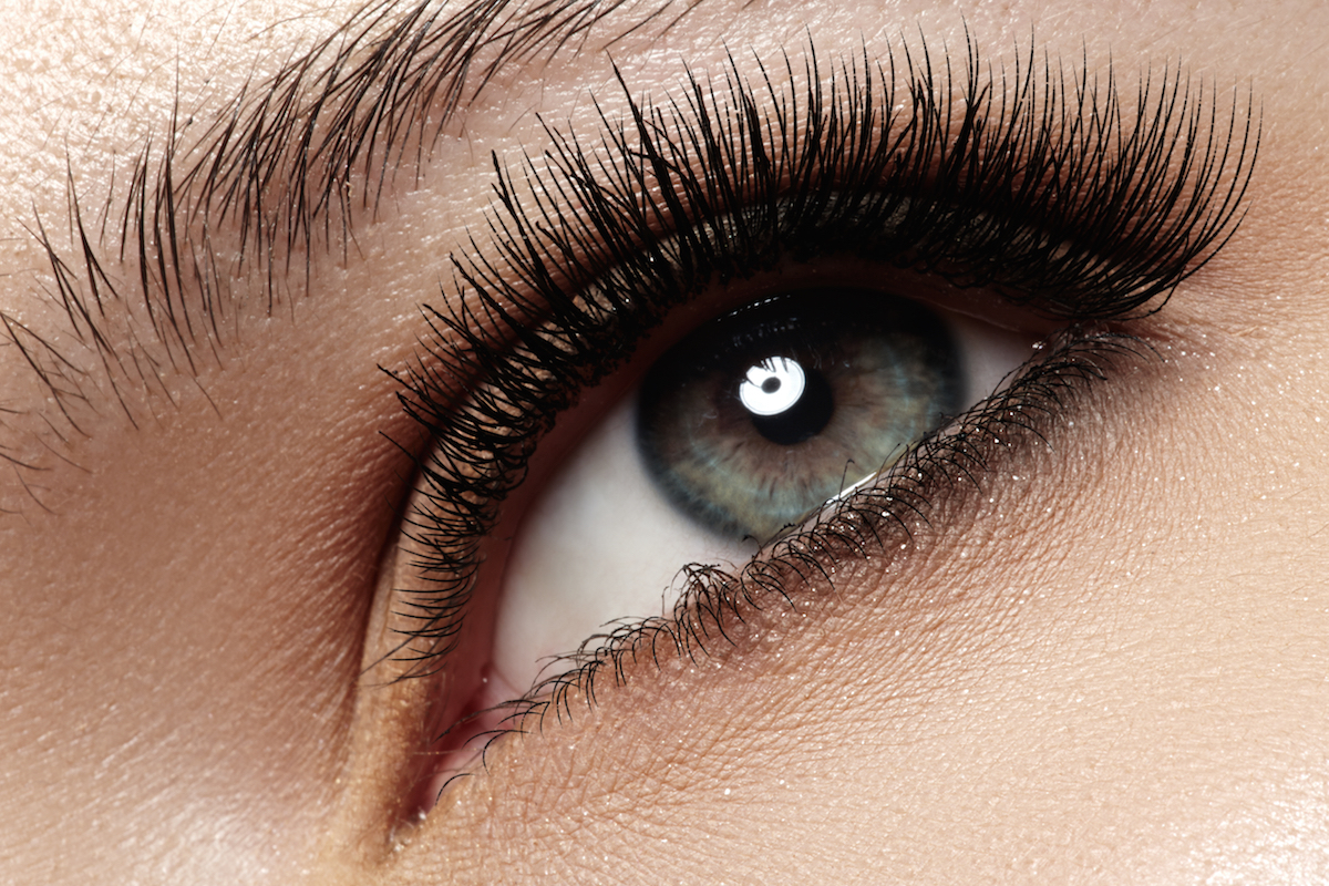 Macro shot of woman's beautiful eye with extremely long eyelashes via Shutterstock