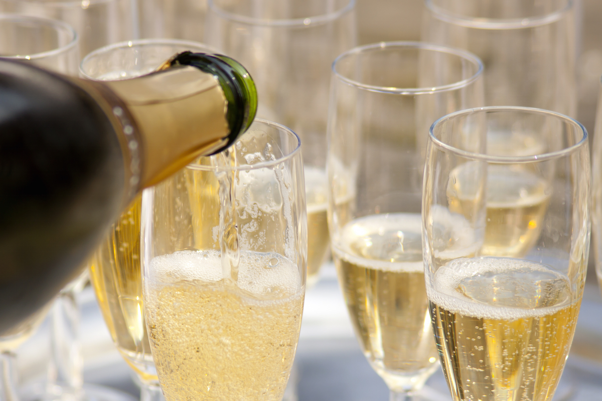 Champagne being poured into glasses via Shutterstock