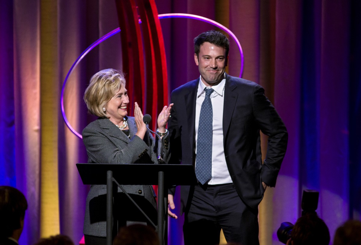 Former Secretary of State Hillary Rodham Clinton applauds actor Ben Affleck, right, during the Clinton Global Initiative's annual awards on Wednesday, Sept. 25, 2013, in New York. Clinton and Joe Biden appeared together during the event. (AP Photo/Craig Ruttle)