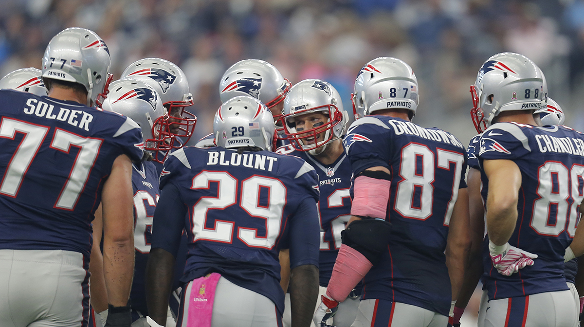 New England Patriots' Tom Brady (12) talks to his teammates in the huddle during the first quarter of an NFL football game against the Dallas Cowboys, Sunday, Oct. 11, 2015, in Arlington, Texas. (AP Photo/Brandon Wade)