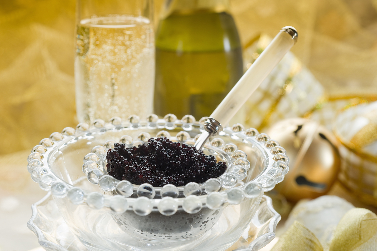 caviar and champagne over luxury table via Shutterstock