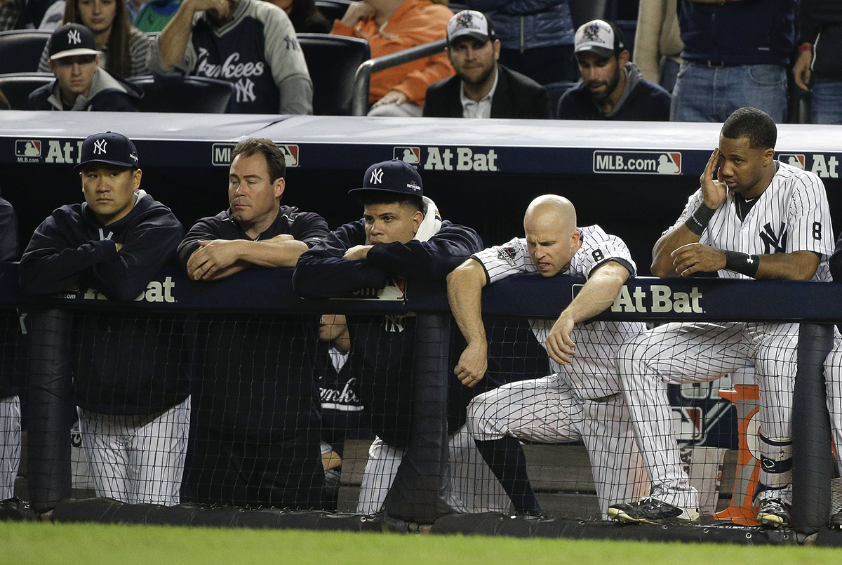 New York Yankees pitcher Masahiro Tanaka, far left, Dellin Betances, second from left, Brett Gardner, second from right, and Chris Young, right, watch from the dugout against the Houston Astros during the ninth inning of the American League wild card baseball game, Tuesday, Oct. 6, 2015, in New York. The Astros won 3-0 to advance to the American League Division Series. (AP Photo/Julie Jacobson)