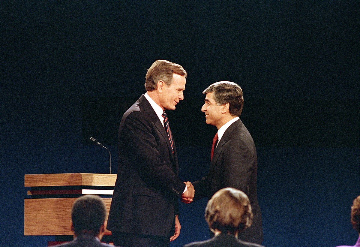 George H.W. Bush and Mike Dukakis at their second debate in 1988. AP Photo/Lennox McLendon