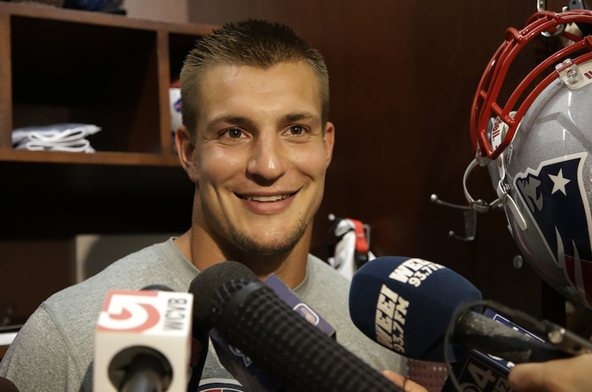 New England Patriots tight end Rob Gronkowski smiles as he talks about  his return to the field during a media availability in front of his locker after practice at the NFL football team's facility in Foxborough, Mass., Wednesday Sept. 4, 2013. The Patriots open their regular season against the Buffalo Bills on Sunday. (AP Photo/Stephan Savoia)