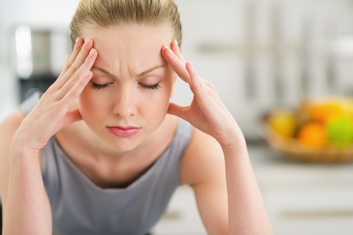 Portrait of a stressed young housewife in a modern kitchen photo via Shutterstock