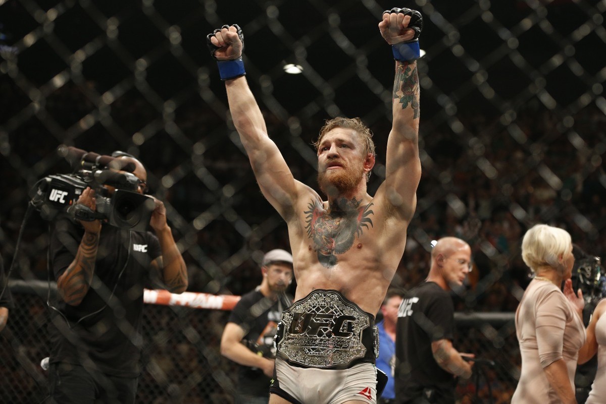 Conor McGregor celebrates after defeating Chad Mendes during their interim featherweight title mixed martial arts bout at UFC 189 Saturday, July 11, 2015, in Las Vegas. (AP Photo/John Locher)