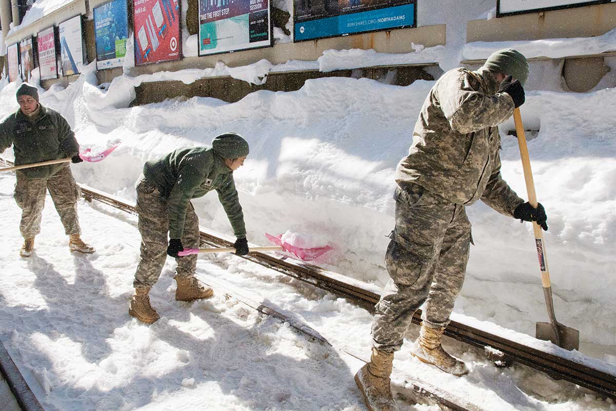 With not enough snowplows, the MBTA called on soldiers last winter to clear the rails with picks, shovels, and brooms. Photo by photograph by Sgt. Michael V. Broughey/the Massachusetts National Guard