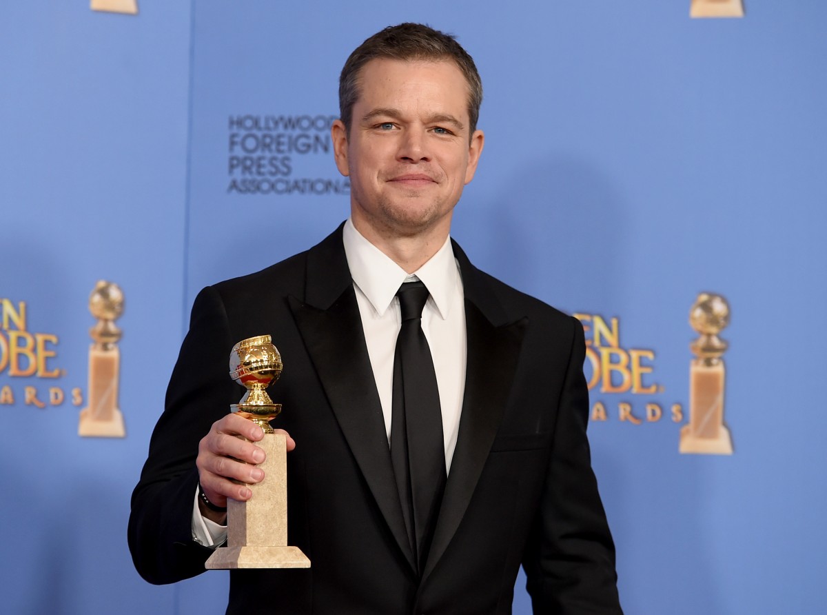 Matt Damon poses in the press room with the award for best performance by an actor in a motion picture - musical or comedy for The Martian at the 73rd annual Golden Globe Awards on Sunday, Jan. 10, 2016, at the Beverly Hilton Hotel in Beverly Hills, Calif. (Photo by Jordan Strauss/Invision/AP)