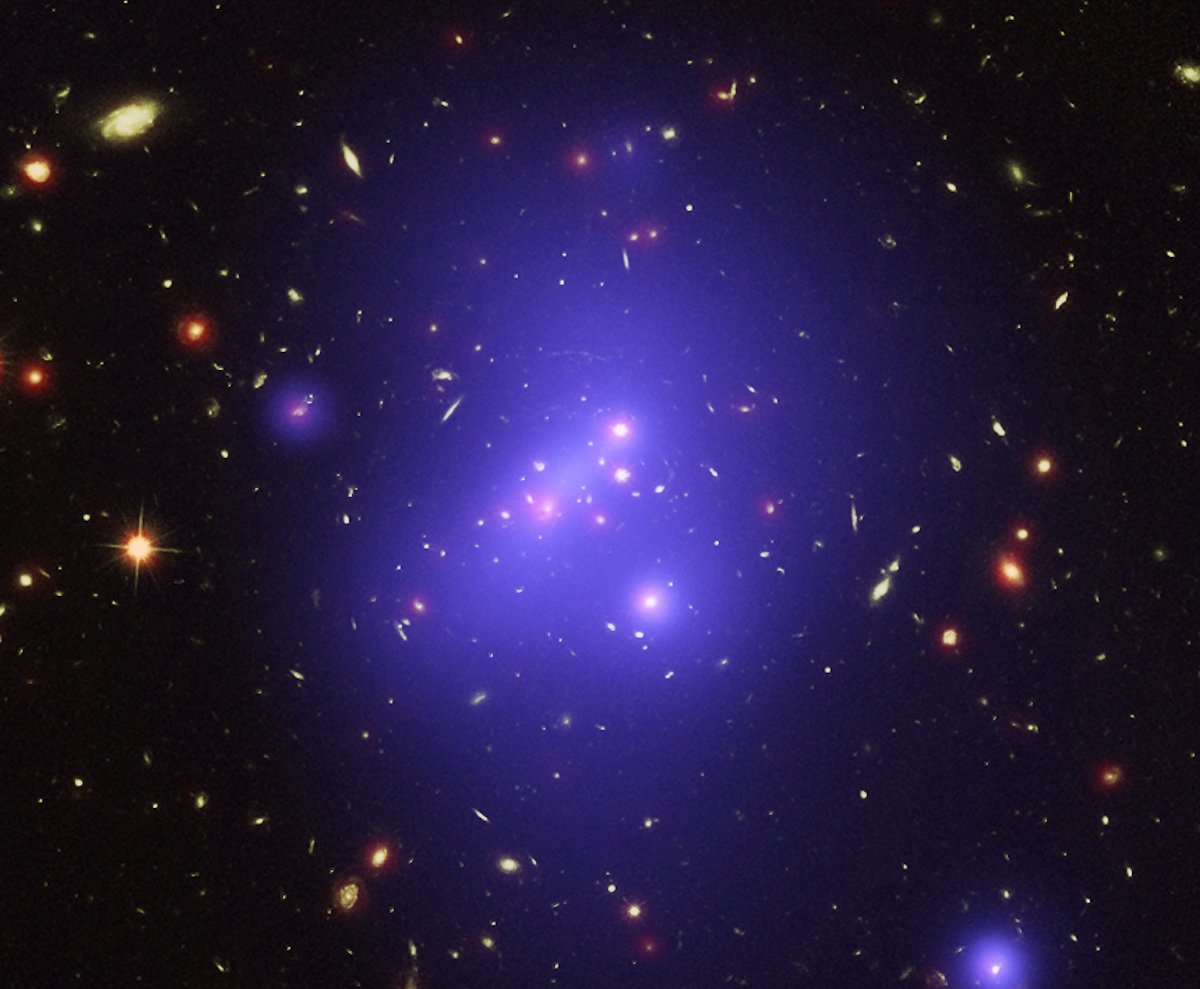 The galaxy cluster shines bright from 10 billion-light years away. Photo via NASA.