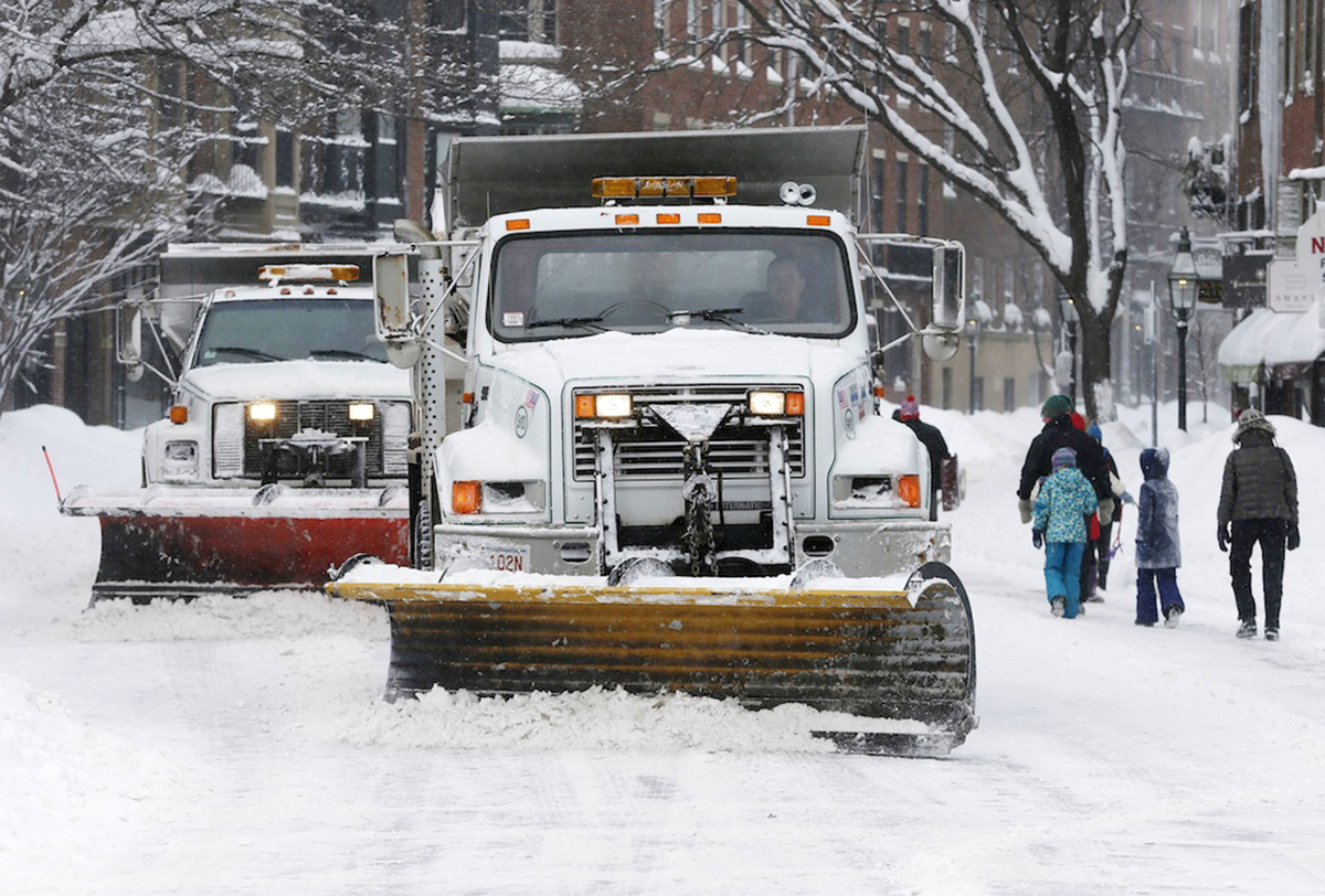 Plows clear Charles Street in Boston, Sunday, Feb. 15, 2015. (AP Photo/Michael Dwyer)