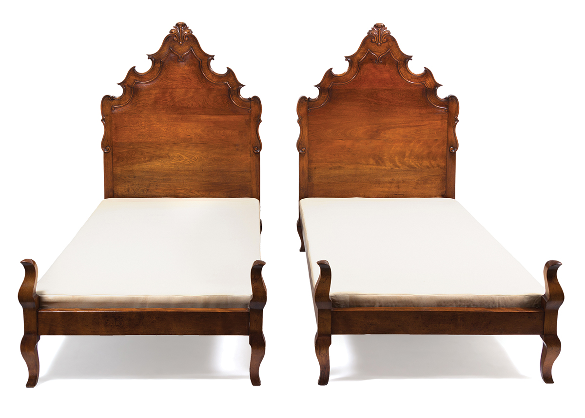 A pair of Venetian-style twin walnut beds