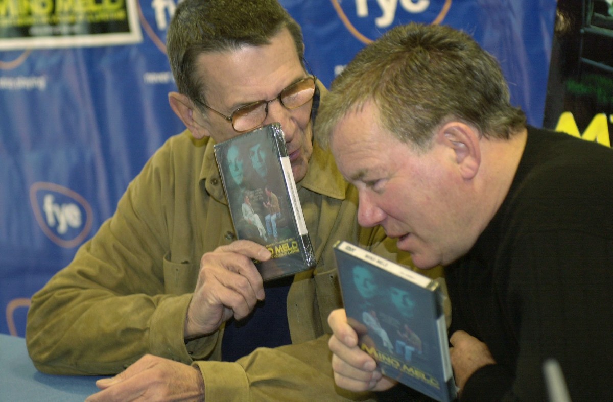 Leonard Nimoy, left, and William Shatner talk privately while autographing copies of their recently released DVD/VHS "Mind Meld: Secrets Behind the Voyage of a Lifetime", Sunday, March 17, 2002, in the Century City section of Los Angeles. Mind Meld is an examination of the impact the Star Trek experience has had on the franchise's two most celebrated participants. (AP Photo/Ric Francis)