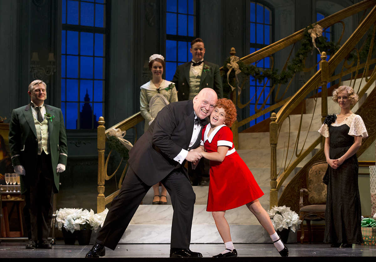 Annie and Daddy Warbucks dance onstage
