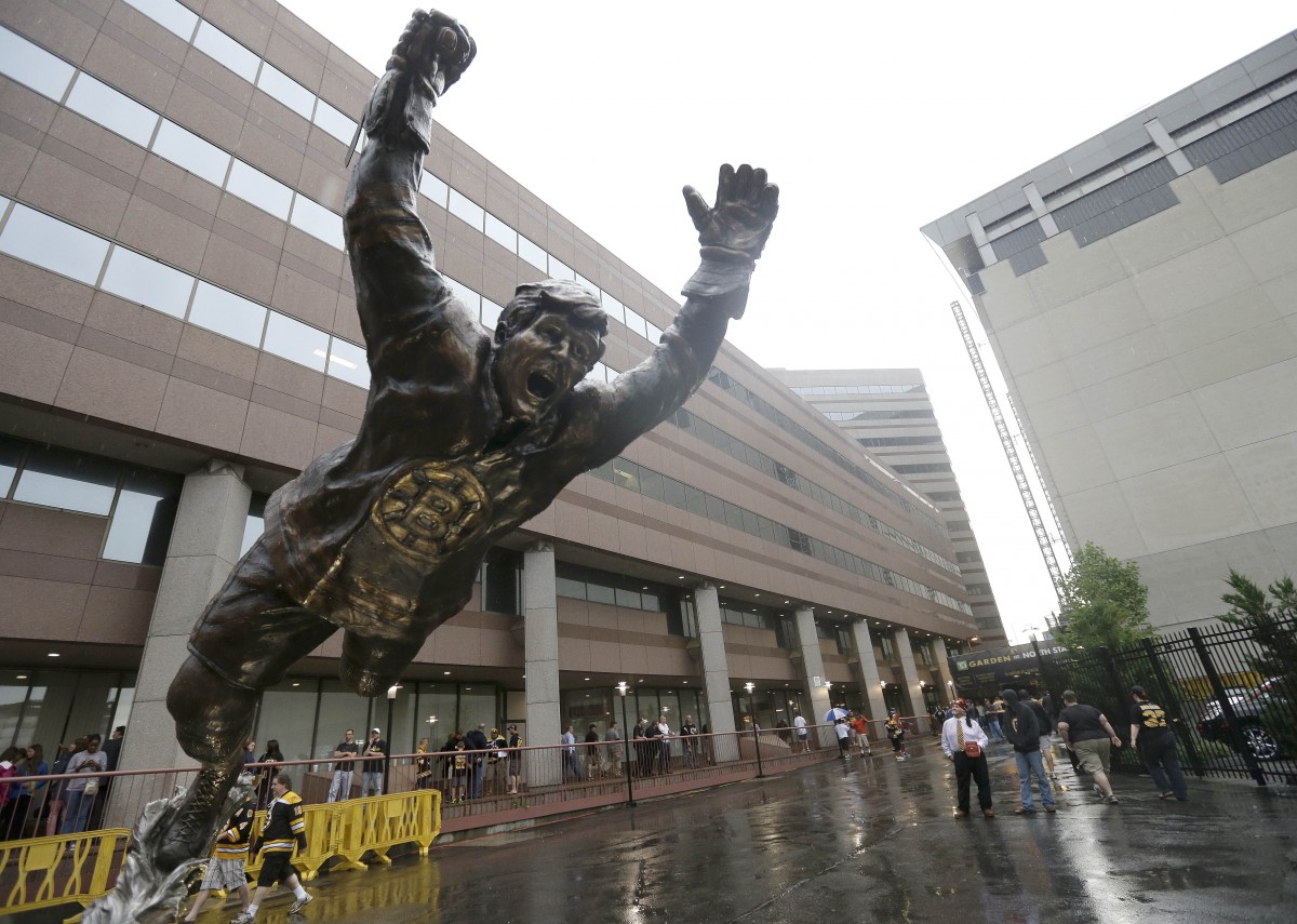 A statue of Boston Bruins legend Bobby Orr soars outside TD Garden before Game 3 of the NHL hockey Stanley Cup Finals between the Boston Bruins and the Chicago Blackhawks in Boston, Monday, June 17, 2013. Orr played for both the Bruins and Blackhawks before retiring in 1978. (AP Photo/Elise Amendola)