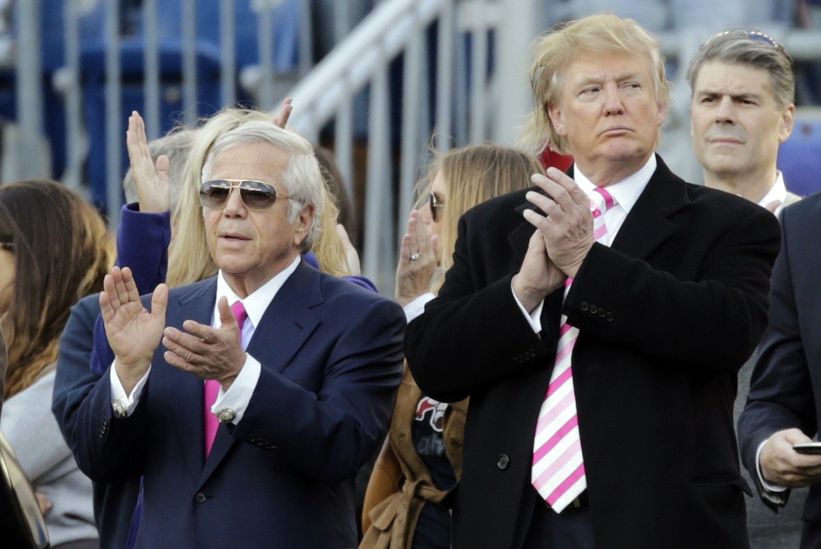 New England Patriots owner Robert Kraft, left, and businessman Donald Trump, right, applaud on the field before an NFL football game between the Patriots and the New York Jets in Foxborough, Mass., Sunday, Oct. 21, 2012. (AP Photo/Charles Krupa)
