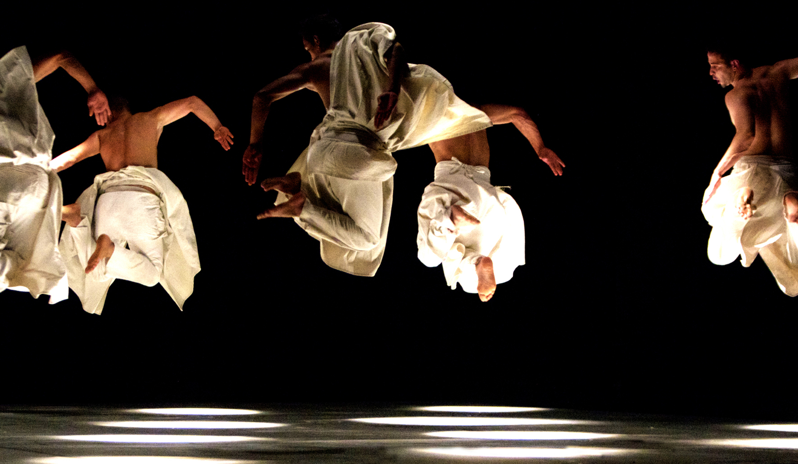 Herve Koub dance troupe leaping on stage