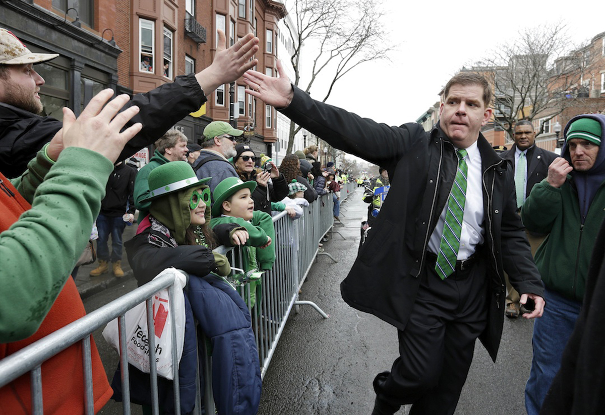 Boston Mayor Marty Walsh, center right, greets spectators while marching in the 2015 St. Patrick's Day Parade (AP Photo/Steven Senne)