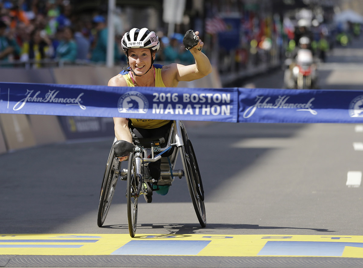 Tatyana McFadden crosses the finish line to win the women's wheelchair division. / PHOTO VIA AP