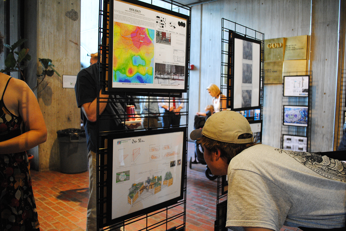 A visitor inspects a project proposal poster. / Photo by Madeline Bilis
