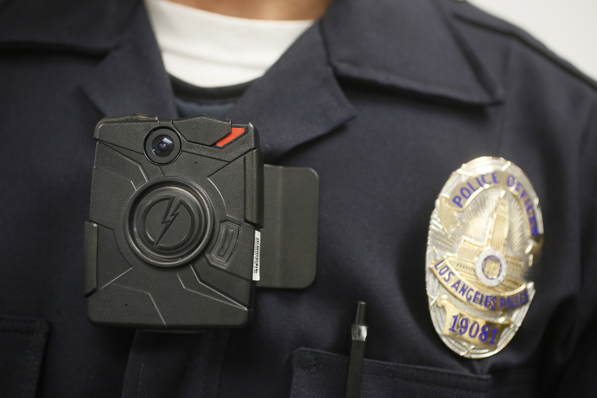 FILE - In this Jan. 15, 2014 file photo, a Los Angeles Police officer wears an on-body camera during a demonstration for media in Los Angeles. The fatal police shooting of the unarmed black teenager in Ferguson, Mo. has prompted calls for more officers to wear so-called "body cameras," simple, lapel-mounted gadgets that record the interactions between the public and law enforcement. (AP Photo/Damian Dovarganes, File)