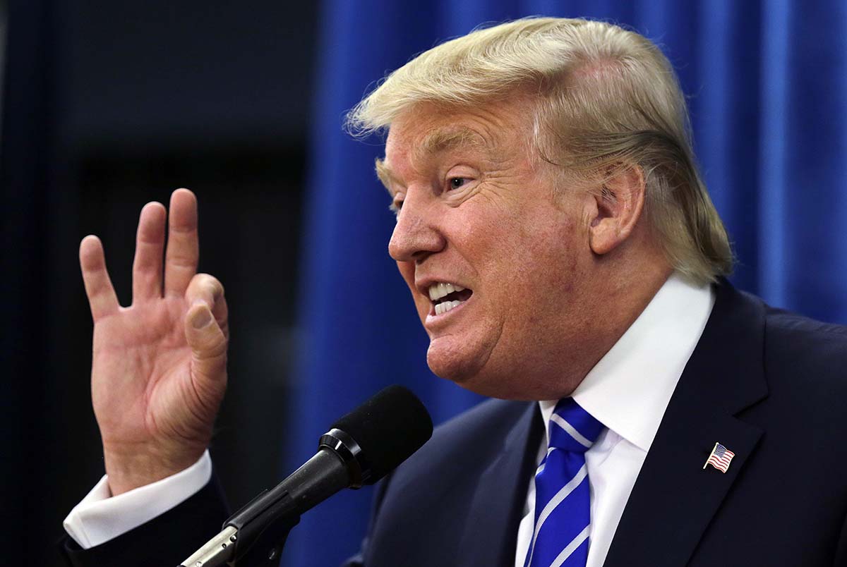 Republican presidential candidate Donald Trump gestures during a media availability prior to a campaign stop at Winnacunnet High School in Hampton, NH, Friday, Aug. 14, 2015. (AP Photo/Charles Krupa)