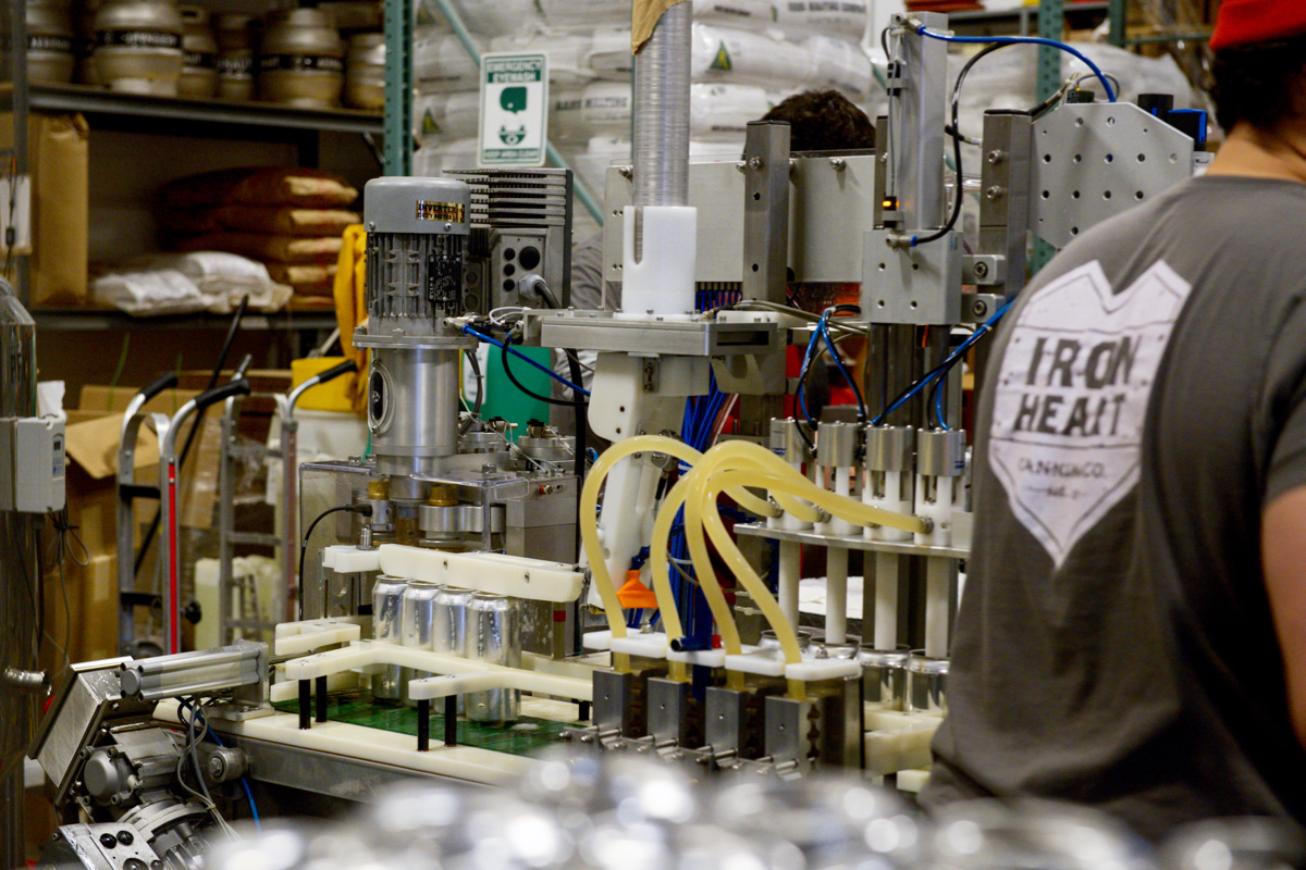 Beer is pumped into 16-ounce cans before they're automatically sealed shut. / Photos by Lloyd Mallison