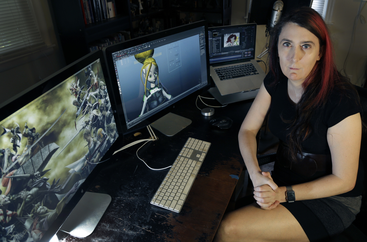 Brianna Wu, a software engineer and video-game developer, sits at her workstation in Boston on July 25, 2016. She has been a prime target of the online harassment campaign known as Gamergate, which subjected several women in the video-game industry to misogynistic threats. It surfaced in the summer of 2014, and hasn't vanished. "It's still a constant drumbeat," said Wu, who became a target after ridiculing those who'd decried women's advances in the male-dominated industry. (AP Photo/Elise Amendola)