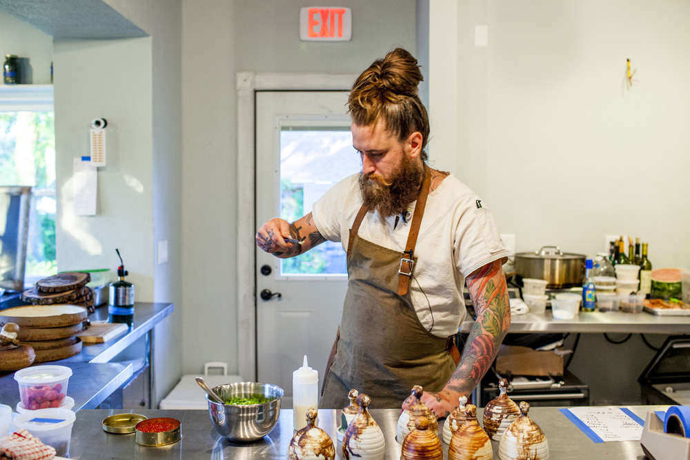 Brandon Baltzley in the kicthen at TMIP , his native food pop-up in Indiana