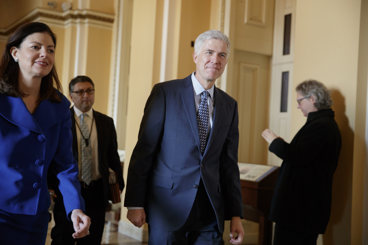 Supreme Court Justice nominee Neil Gorsuch, right, is escorted by former New Hampshire Sen. Kelly Ayotte on the way to a meeting with Sen. Ted Cruz, R-Texas, a member of the Senate Judiciary Committee, Thursday, Feb. 2, 2017, on Capitol Hill in Washington. (AP Photo/J. Scott Applewhite)