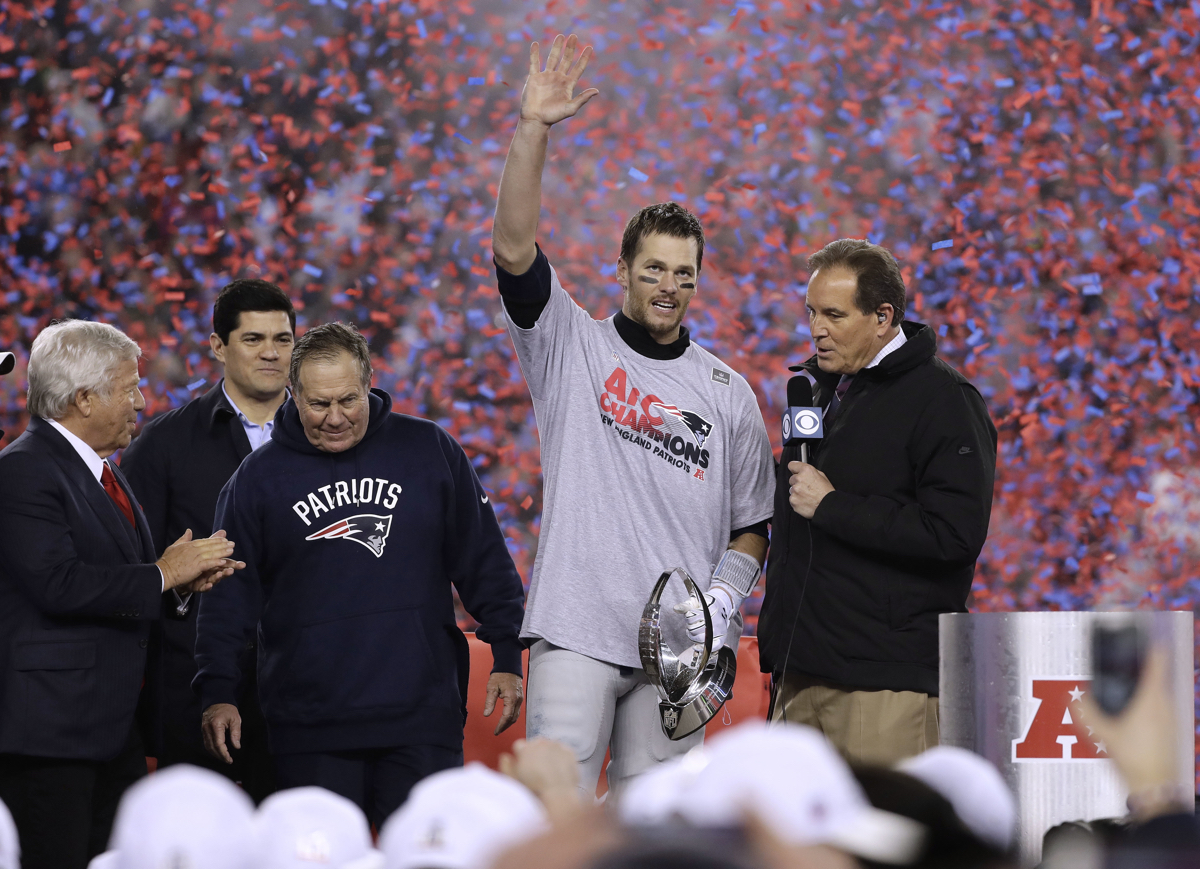 CBS announcer Jim Nantz, right, interviews New England Patriots quarterback Tom Brady, second from right holding the AFC championship trophy, beside team owner Robert Kraft, left, honorary captain Tedy Bruschi, second from left, and head coach Bill Belichick after the AFC championship NFL football game, Sunday, Jan. 22, 2017, in Foxborough, Mass. The Patriots defeated the the Pittsburgh Steelers 36-17 to advance to the Super Bowl. (AP Photo/Matt Slocum)