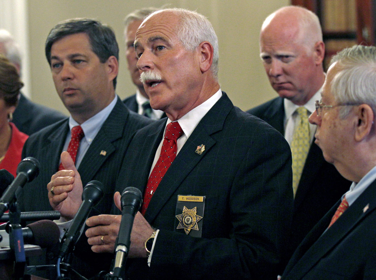 Bristol County Sheriff Thomas Hodgson gestures during a news conference in regard to the "Secure Communities" program, or "S Comm", held by Massachusetts county sheriffs at the Statehouse in Boston, Wednesday, Sept. 28, 2011. The program is designed to immediately check the immigration status of those arrested for crimes. Opponents say it will lead to profiling.(AP Photo/Charles Krupa)