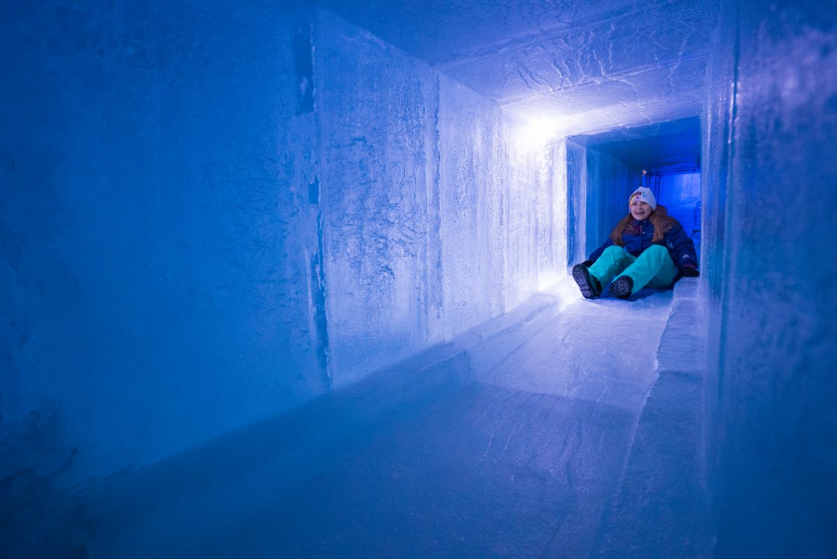 A child slides through an icy tunnel. / Photo provided